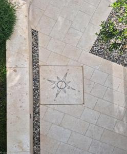 Un camino de piedra con una estrella en la acera. en Concha Aurea Apartments, en Sveti Juraj 17 fotos más