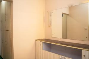 a bathroom with a mirror on the wall at Aarya Wellness & Hostel in Kathmandu +59 photos