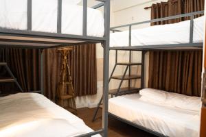 a room with three bunk beds and a ladder at Aarya Wellness & Hostel in Kathmandu
