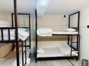 a room with three bunk beds in a room at Hostel sakura Jaisalmer in Jaisalmer +4 photos