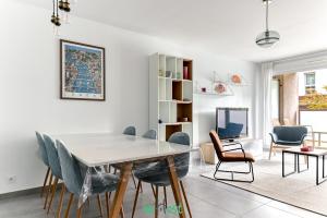 a dining room with a table and chairs at Vinatier - Lyon 2 - LB - Large family apartment with parking in Lyon in Bron