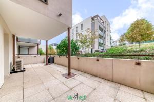 an empty balcony of a building with a fence at Vinatier - Lyon 2 - LB - Large family apartment with parking in Lyon in Bron