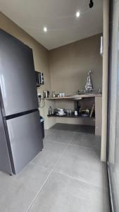 a kitchen with a stainless steel refrigerator in a room at Izinga Game Karoo Guest Farm in Philipstown +15 photos