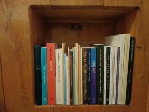 a row of books on a book shelf at Poëziehotel Surplace - 15 min van Pairi Daiza & industriezone Ghislenghien in Bever