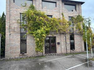 a brick building with a tree in front of it at Open Concept Boutique Hotel - free breakfast & parking in Belgrade