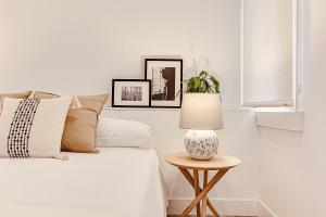 a bedroom with a bed and a table with a lamp at Main Street Deluxe in A Coruña