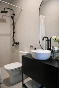 a bathroom with a sink and a toilet and a mirror at Open Concept Boutique Hotel - free breakfast & parking in Belgrade