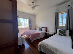 En eller flere senge i et værelse på Village Itaúna Inn - Casas de Temporada + 283 billeder