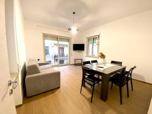 a living room with a table and a couch at A casa di Adele in Taormina
