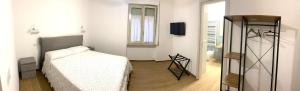 a small bedroom with a bed and a window at A casa di Adele in Taormina