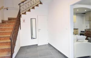 a hallway with a stairway leading up to a room with a bed at Nice Home In Longarone With Wifi in Faè