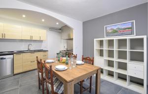 a kitchen with a wooden table and chairs at Nice Home In Longarone With Wifi in Faè