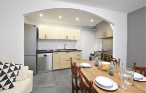 a kitchen and dining room with a table and chairs at Nice Home In Longarone With Wifi in Faè
