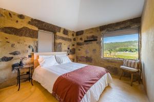a bedroom with a bed and a large window at Lemon Villa with Private Indoor Heated Pool - Oporto Lemon Farm, near Porto in Valpedre +71 photos