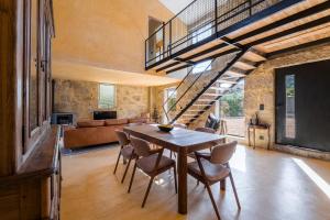 a dining room with a wooden table and chairs at Lemon Villa with Private Indoor Heated Pool - Oporto Lemon Farm, near Porto in Valpedre