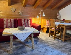 a living room with a table and a couch at Ferienwohnungen Haid in Schönau am Königssee