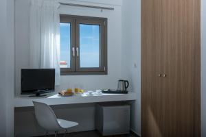 a room with a desk with a computer and a window at Bianca Doma Adults Only by Estia in Hersonissos