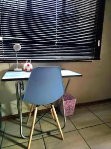 a blue chair sitting in front of a desk at Waterworks Overnights in Kimberley