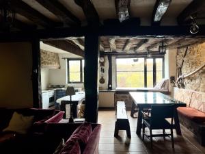 a living room with a table and a couch at Casa rural Villapajar in Villasur de Herreros +36 photos