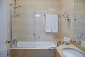 Un baño con bañera, lavabo y ducha. en Hotel Toural, en Guimarães 47 fotos más