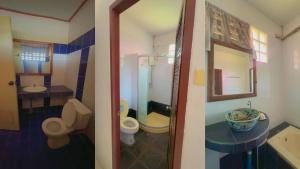 a bathroom with two toilets and a sink and a mirror at OYO 75597 The Tewsone Resort in Sukhothai +27 photos