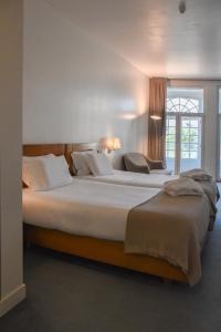 Postel nebo postele na pokoji v ubytování Hotel Toural