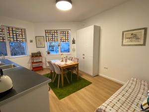 a kitchen and dining room with a table in a room at The Clock house in Samokov