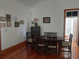 a dining room with a table and chairs at Coda in Umkomaas