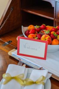a plate of strawberries and a bowl of fruit at Hotel Isabella in Taormina