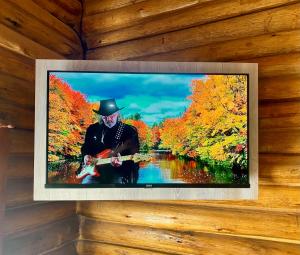 a picture of a man playing a guitar on a wall at Cabañas LA EMILIA Uspallata Mdz in Uspallata