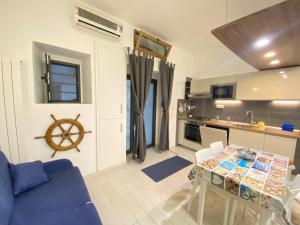 a living room with a blue couch and a table at Casa sinuessa in Gaeta