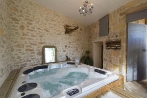 a large bath tub in a room with at Le Clos Réaud in Blaye