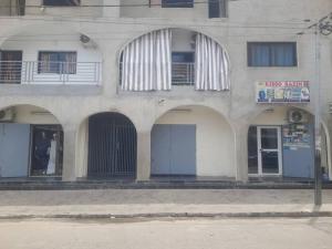 a building with arched windows and doors on a street at Studio YaciAdjo in Abidjan