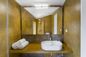 a bathroom with a sink and a mirror at Romantic Lemon Grove Cottage with Private Pool - Oporto Lemon Farm, near Porto in Valpedre +43 photos