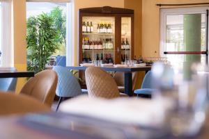 a restaurant with a table and chairs and a window at Hotel Capannelle Roma in Rome