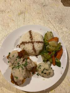 a plate of food with rice and vegetables on a table at DesertGlow camp in Merzouga