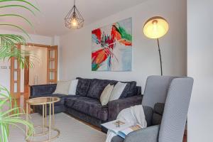 a living room with a couch and a table at Blue Ocean Apartment in A Coruña
