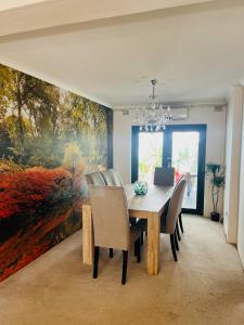 a dining room with a large painting on the wall at LaPoch Guesthouse in Durban