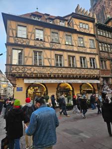 a group of people walking in front of a building at Grand appartement de 140m2 en plein centre-ville in Strasbourg