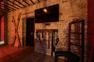 a room with a wall with ski equipment on it at loveroom le donjon in Anse