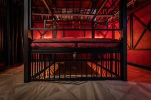 an open cage with two beds in a room at loveroom le donjon in Anse