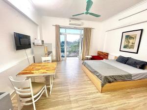 a bedroom with a bed and a dining room table at CHILLING SUDIO 11 Trinh Cong Son close Ho Tay vs Lotte mail ! in Hanoi