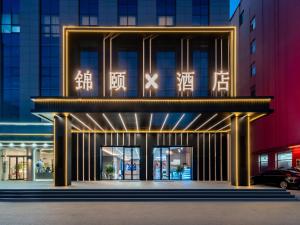 a building with lights on the front of it at Jin Yi X Hotel in Hekou