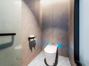a bathroom with a toilet with blue lights on it at Jin Yi X Hotel in Hekou +17 photos