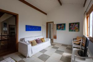巴拉尤娜Casa Alto Padrao com 5 Suites e Jacuzzi Privativa的客厅里有一张沙发，墙上挂着画 更多41张照片