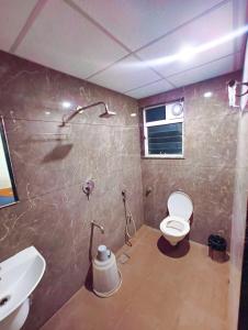 a bathroom with a toilet and a sink at Apex Inn Manyata in Bangalore +11 photos