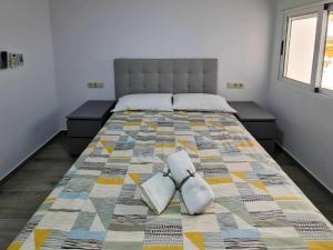 a bedroom with a bed with two pillows on it at Apartalux Villa Playa in Benidorm