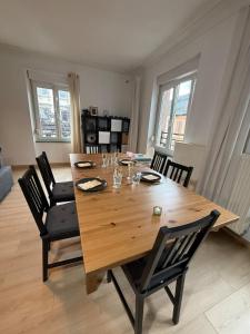 a dining room table with chairs and a large wooden table at Colmar St Joseph Nature Cocoon in Colmar +9 photos