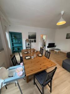a living room with a wooden table and chairs at Colmar St Joseph Nature Cocoon in Colmar