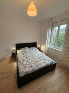 a bedroom with a bed and a large window at Colmar St Joseph Nature Cocoon in Colmar